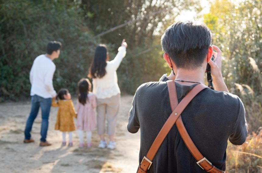 man in black and brown backpack walking on street during daytime