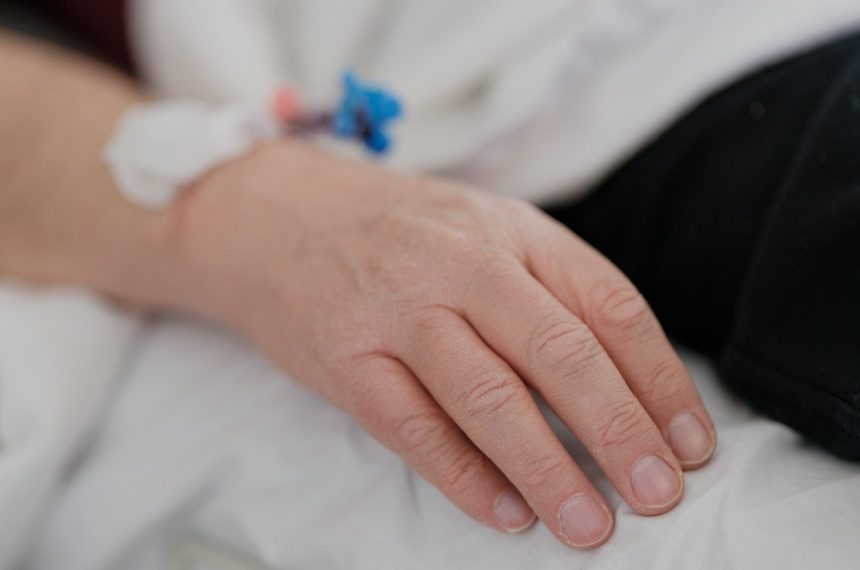 a close up of a person's hand on a bed
