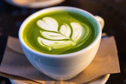 white ceramic teacup filled of matcha tea