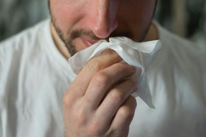 man wiping mouse with tissue paper