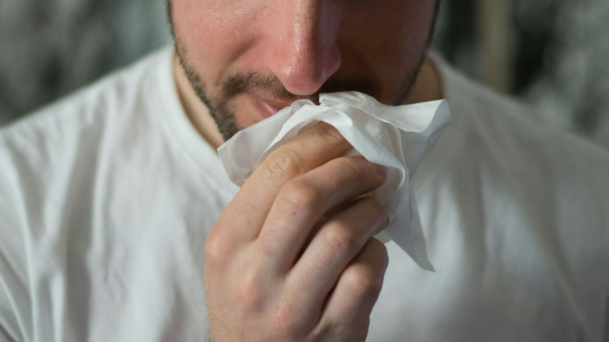 man wiping mouse with tissue paper