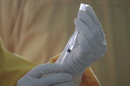 person holding white plastic tube
