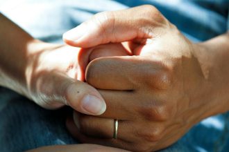 person wearing gold wedding band