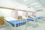 empty hospital bed inside room